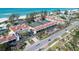 Aerial view showcasing a coastal community with tennis courts and beachfront access near Gulf of Mexico at 5055 Gulf Of Mexico Dr # 414, Longboat Key, FL 34228