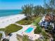 Aerial view of beachfront condos with a pool and beach access at 5055 Gulf Of Mexico Dr # 414, Longboat Key, FL 34228