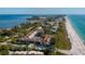 Breathtaking aerial view of a coastal community with stunning beach and bay views and beautiful landscaping at 5055 Gulf Of Mexico Dr # 414, Longboat Key, FL 34228