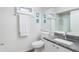 Clean bathroom featuring granite countertop, white cabinets, and nautical themed art at 5055 Gulf Of Mexico Dr # 414, Longboat Key, FL 34228