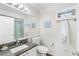 Bathroom features a granite countertop, shower, a large mirror and neutral wall art at 5055 Gulf Of Mexico Dr # 414, Longboat Key, FL 34228