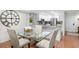Dining area featuring a glass table and chairs, with view of the kitchen at 5055 Gulf Of Mexico Dr # 414, Longboat Key, FL 34228