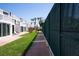 Exterior condo view with tennis courts, beach access, and tropical landscape at 5055 Gulf Of Mexico Dr # 414, Longboat Key, FL 34228