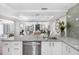 Updated kitchen with stainless steel dishwasher, granite countertops, and open layout at 5055 Gulf Of Mexico Dr # 414, Longboat Key, FL 34228