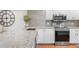 Close-up of the updated kitchen featuring modern appliances, granite countertops, and ample storage at 5055 Gulf Of Mexico Dr # 414, Longboat Key, FL 34228