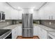 Bright kitchen featuring stainless steel refrigerator and granite countertops at 5055 Gulf Of Mexico Dr # 414, Longboat Key, FL 34228
