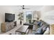 Bright living room with a view of the outdoor patio through shuttered glass doors at 5055 Gulf Of Mexico Dr # 414, Longboat Key, FL 34228