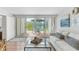 Living room with sliding glass doors to outside patio with view of landscaping at 5055 Gulf Of Mexico Dr # 414, Longboat Key, FL 34228