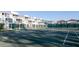 Scenic view of pristine tennis courts, surrounded by lush greenery and well-maintained landscaping at 5055 Gulf Of Mexico Dr # 414, Longboat Key, FL 34228