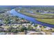 Scenic aerial view showcasing a stunning river, lush greenery, and surrounding homes at 5206 18Th E Ave, Bradenton, FL 34208