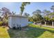 Backyard with shed and dock with boats, offering waterfront living and storage solutions at 5206 18Th E Ave, Bradenton, FL 34208