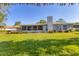 View of the backyard featuring a green lawn and seating at 5206 18Th E Ave, Bradenton, FL 34208