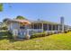 Charming backyard featuring a seating area, string lights, and green lawn at 5206 18Th E Ave, Bradenton, FL 34208