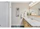 Bathroom with marble countertops, wooden cabinetry, a shower, and decorative accents at 5206 18Th E Ave, Bradenton, FL 34208