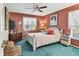 Charming bedroom with a white bed, cozy chair, and ample natural light from the window at 5206 18Th E Ave, Bradenton, FL 34208