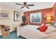 Bedroom with white bed frame, white window sheers, and a coral colored accent wall at 5206 18Th E Ave, Bradenton, FL 34208