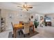 This light-filled dining room includes coastal decor and seating for four at a wood table on an area rug at 5206 18Th E Ave, Bradenton, FL 34208