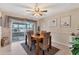 This dining room offers wood floors, a ceiling fan, and water views from sliding glass doors to the lanai at 5206 18Th E Ave, Bradenton, FL 34208