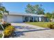 Charming single-story home featuring an attached two-car garage, arched entryway and well-manicured lawn at 5206 18Th E Ave, Bradenton, FL 34208