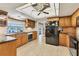 This kitchen boasts oak cabinets, granite counters, stainless appliances and a view of the waterfront at 5206 18Th E Ave, Bradenton, FL 34208