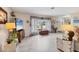 Open living room with tile flooring, natural light, and views of the landscaped front yard at 5206 18Th E Ave, Bradenton, FL 34208