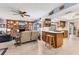 Open living space featuring a brick fireplace, built-in shelving, and an island with counter seating at 5206 18Th E Ave, Bradenton, FL 34208