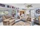Inviting living room with nautical decor, comfortable seating, and seamless access to a screened lanai at 5206 18Th E Ave, Bradenton, FL 34208