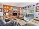 The spacious living room features a brick fireplace, built-in shelving, and access to a lanai at 5206 18Th E Ave, Bradenton, FL 34208