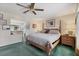 Cozy main bedroom with a four-poster bed, en-suite bathroom, and soothing color scheme at 5206 18Th E Ave, Bradenton, FL 34208