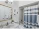 Bathroom with tub and blue striped shower curtain, and vanity at 5382 Royal Palm Ave # 5382, Sarasota, FL 34234