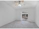 Bright bedroom features neutral carpet, ceiling fan, and sliding glass doors at 5382 Royal Palm Ave # 5382, Sarasota, FL 34234