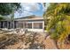Exterior view of the enclosed lanai and patio area with stone table at 5382 Royal Palm Ave # 5382, Sarasota, FL 34234