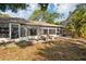 Exterior view of the enclosed lanai and patio area with stone table at 5382 Royal Palm Ave # 5382, Sarasota, FL 34234