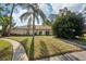 Charming single-story home featuring a well-manicured lawn, mature landscaping, and a welcoming front entrance at 5382 Royal Palm Ave # 5382, Sarasota, FL 34234