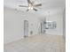 Open-concept living room showcasing tiled floors, a ceiling fan, and seamless connectivity to the kitchen and other living spaces at 5382 Royal Palm Ave # 5382, Sarasota, FL 34234
