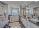 Luxurious bathroom featuring a large tub, walk-in shower, and and sinks with granite countertop at 5554 Eastwind Dr, Sarasota, FL 34233