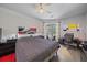 This stylish bedroom offers a ceiling fan, desk area, and sliding glass doors with outdoor access at 5554 Eastwind Dr, Sarasota, FL 34233