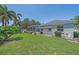 Well maintained property featuring a screened in patio and lush lawn at 5554 Eastwind Dr, Sarasota, FL 34233