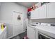 Practical laundry room featuring modern washer and dryer, with storage cabinets, for efficient chores at 5554 Eastwind Dr, Sarasota, FL 34233