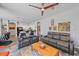 Open living room featuring leather sofas, tile floors, and views into the kitchen at 5554 Eastwind Dr, Sarasota, FL 34233