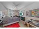 Bright bedroom with patterned bedspread, ceiling fan, and a view of the outside at 5554 Eastwind Dr, Sarasota, FL 34233