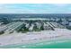 Breathtaking aerial view of the pristine beach and surrounding cityscape at 5920 Midnight Pass Rd # 406, Sarasota, FL 34242
