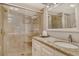 Updated bathroom features a glass shower, granite counters and a vanity at 5920 Midnight Pass Rd # 406, Sarasota, FL 34242