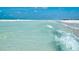 Gorgeous beach features sparkling turquoise water, gently rolling waves and pearly white sand at 5920 Midnight Pass Rd # 406, Sarasota, FL 34242