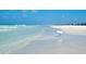 Beautiful beach view showcases the stunning contrast of white sands against the crystal turquoise water at 5920 Midnight Pass Rd # 406, Sarasota, FL 34242