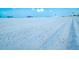 Close up view of beach sand featuring light, fine sand and tire tracks across a wide open space at 5920 Midnight Pass Rd # 406, Sarasota, FL 34242