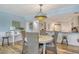 Open dining area features a round table, seating for four, and a unique chandelier at 5920 Midnight Pass Rd # 406, Sarasota, FL 34242