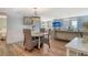 Comfortable dining area with wood floors, coastal decor, and ocean views at 5920 Midnight Pass Rd # 406, Sarasota, FL 34242