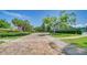 Long brick driveway surrounded by green lawns and meticulously manicured hedges at 5920 Midnight Pass Rd # 406, Sarasota, FL 34242