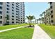 Well-manicured lawn with walkway leading to beach at 5920 Midnight Pass Rd # 406, Sarasota, FL 34242